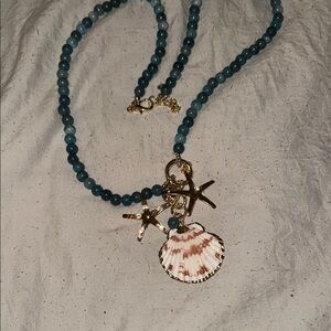 Elegant Teal Beaded Necklace with Gold Starfish and Shell Pendant